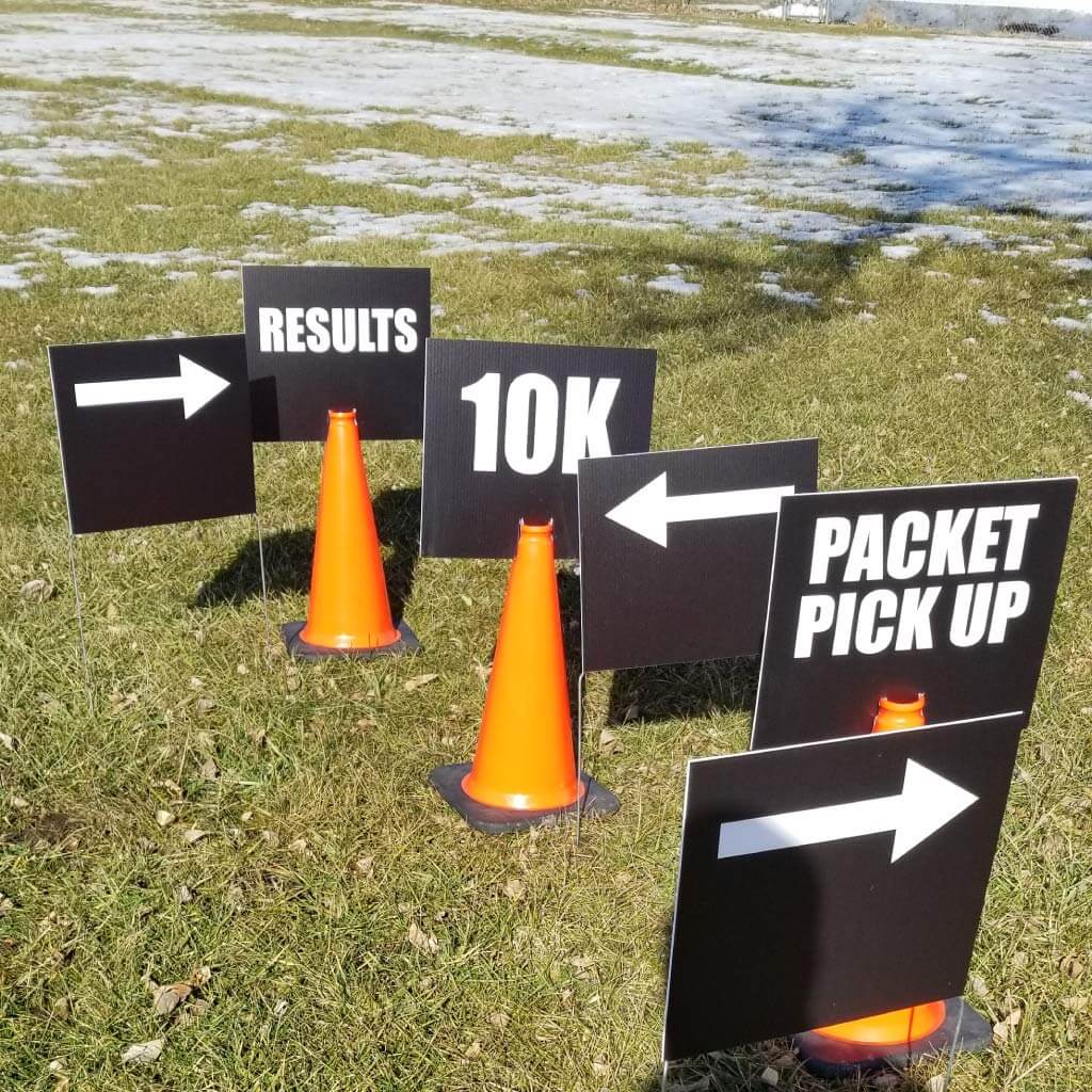 Race course directional signs displayed with traffic cones