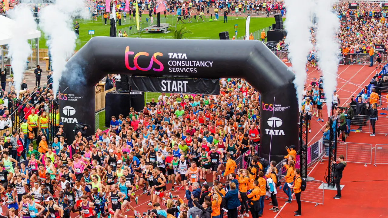 Large road race starting beneath a branded inflatable arch